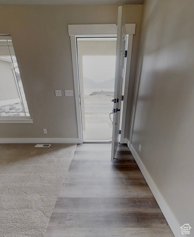 Foyer entrance featuring wood finished floors and baseboards