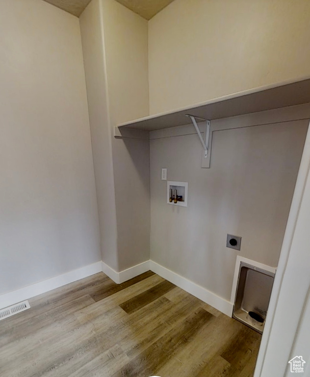 Washroom featuring wood finished floors, washer hookup, and hookup for an electric dryer
