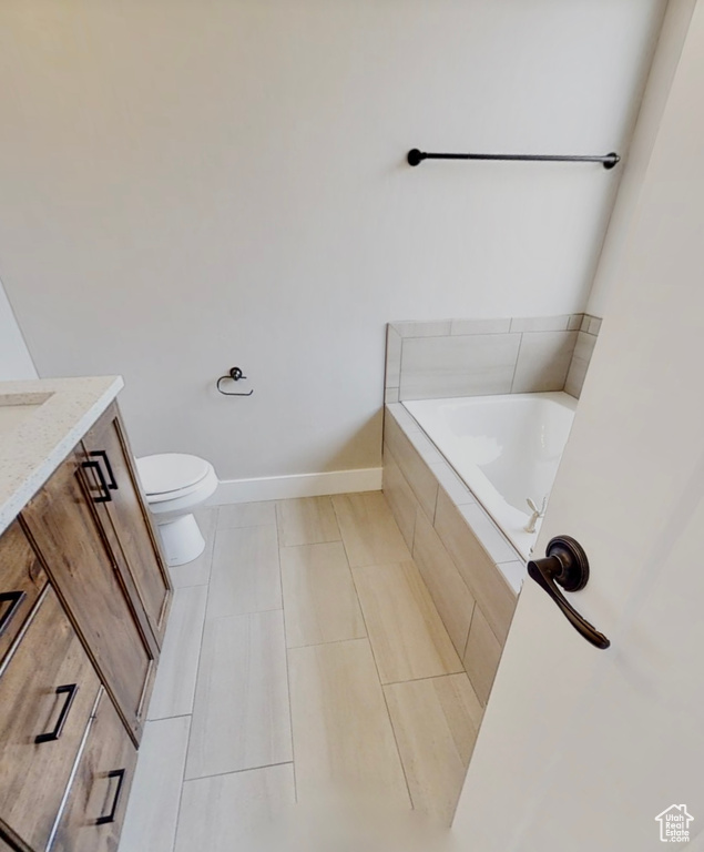 Bathroom with a garden tub, vanity, and tile patterned floors