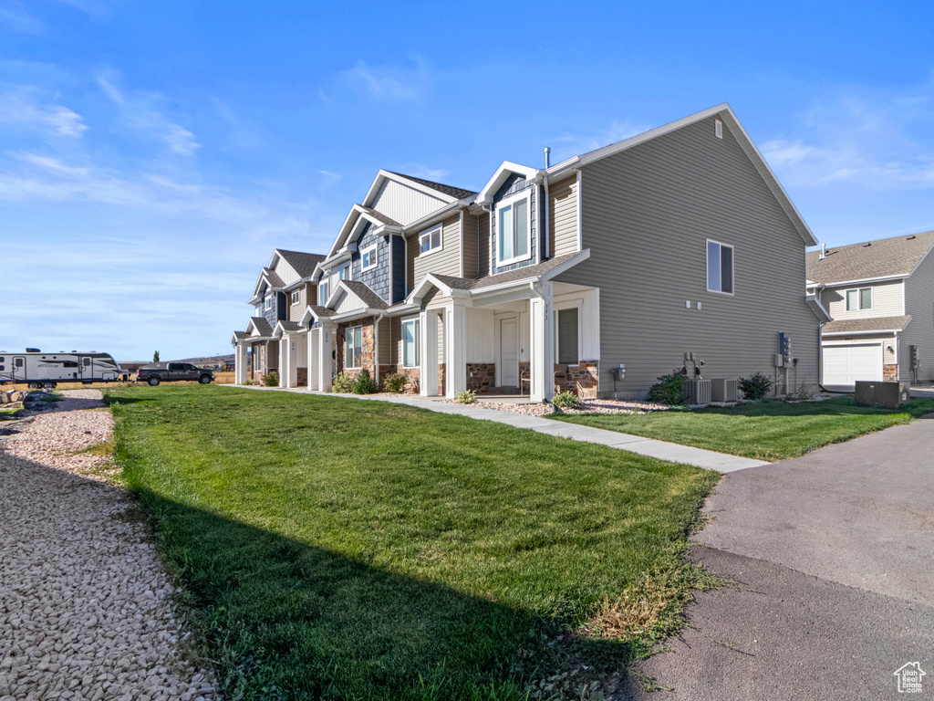 View of side of property with a residential view and a yard