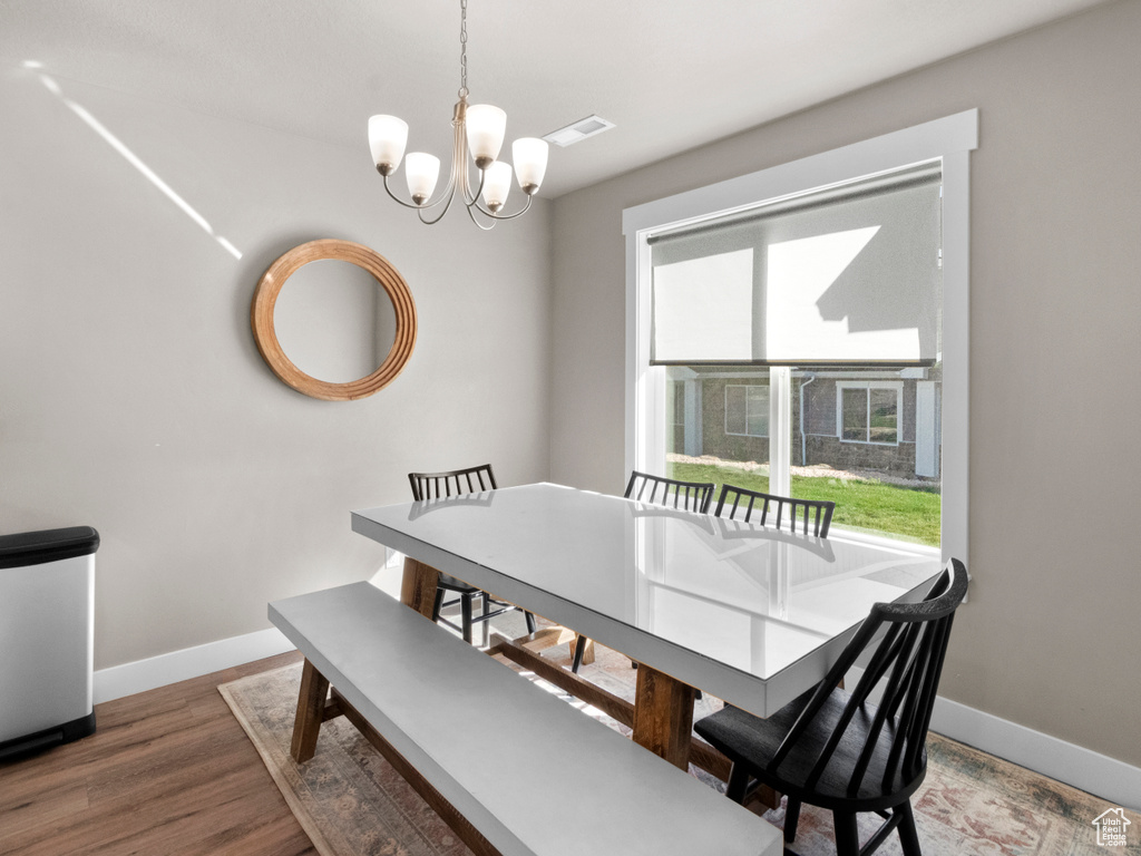 Dining room featuring a chandelier and wood finished floors