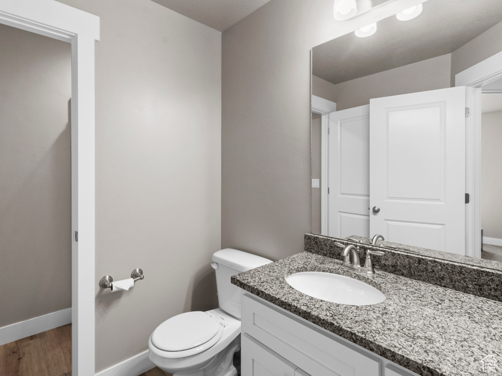 Bathroom featuring vanity and wood finished floors