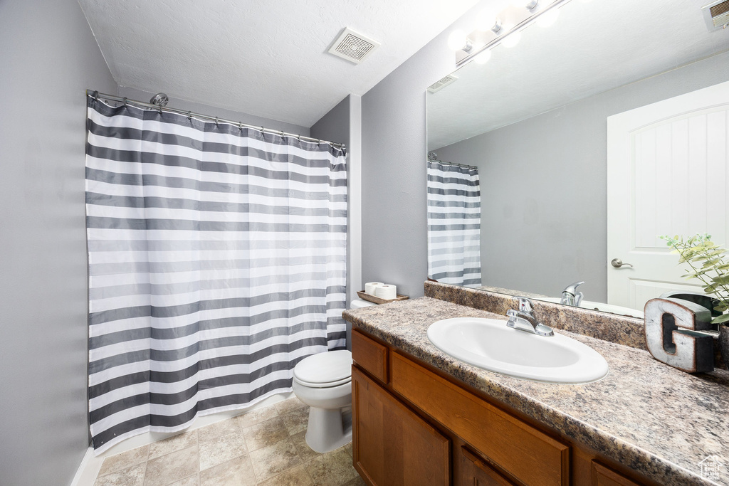 Full bathroom with toilet and vanity