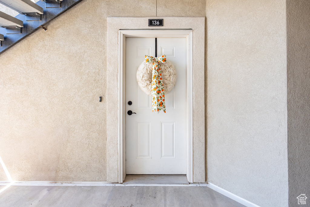 Doorway to property with stucco siding