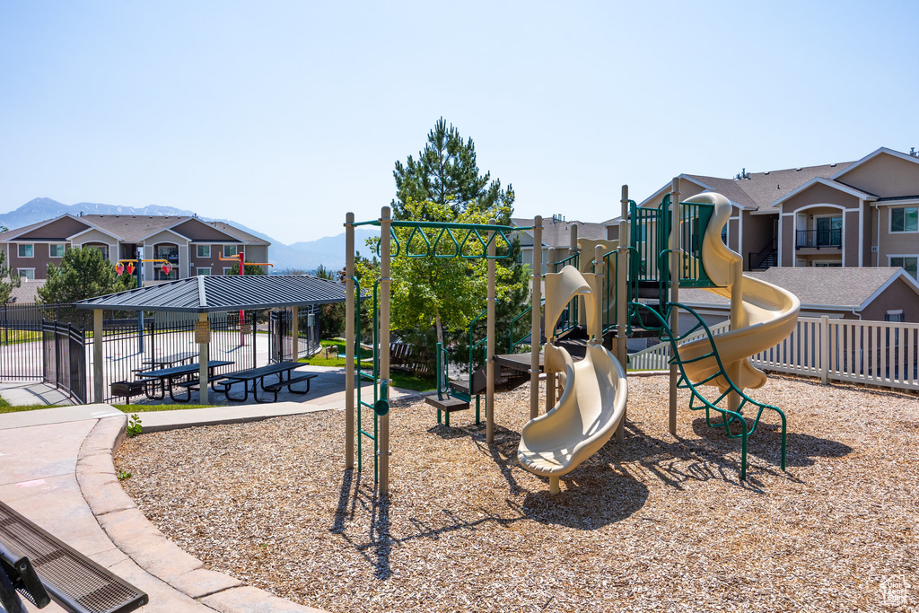 Community play area featuring a mountain view, a gazebo, and a residential view