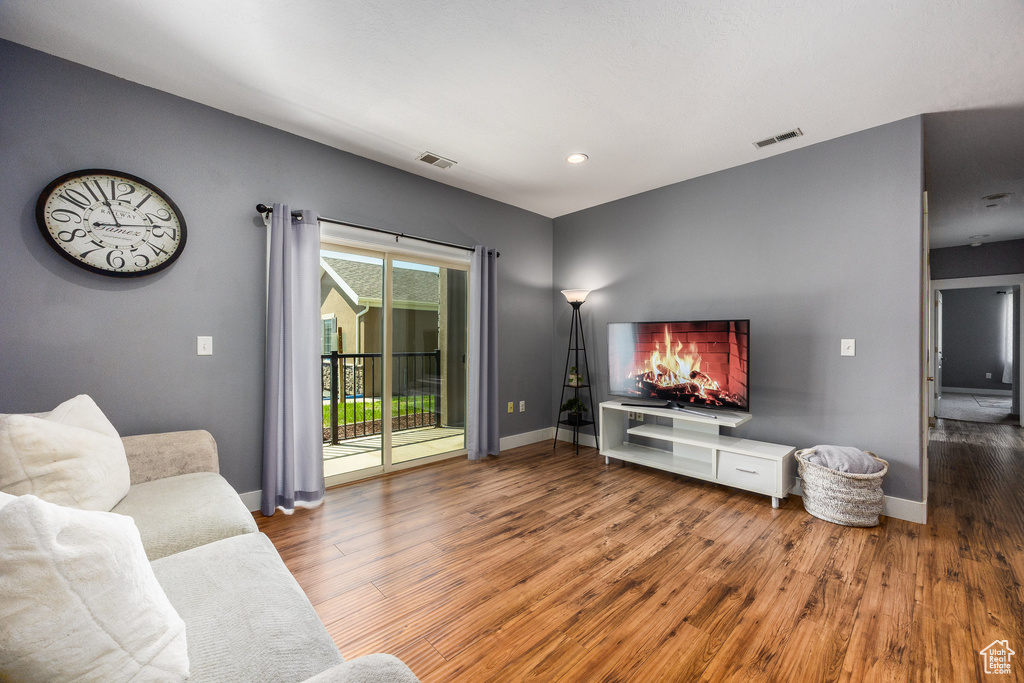 Living area featuring wood finished floors and recessed lighting