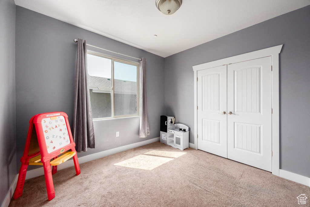 Game room featuring carpet floors and baseboards