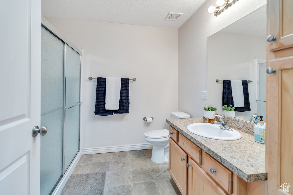 Bathroom featuring vanity and a stall shower