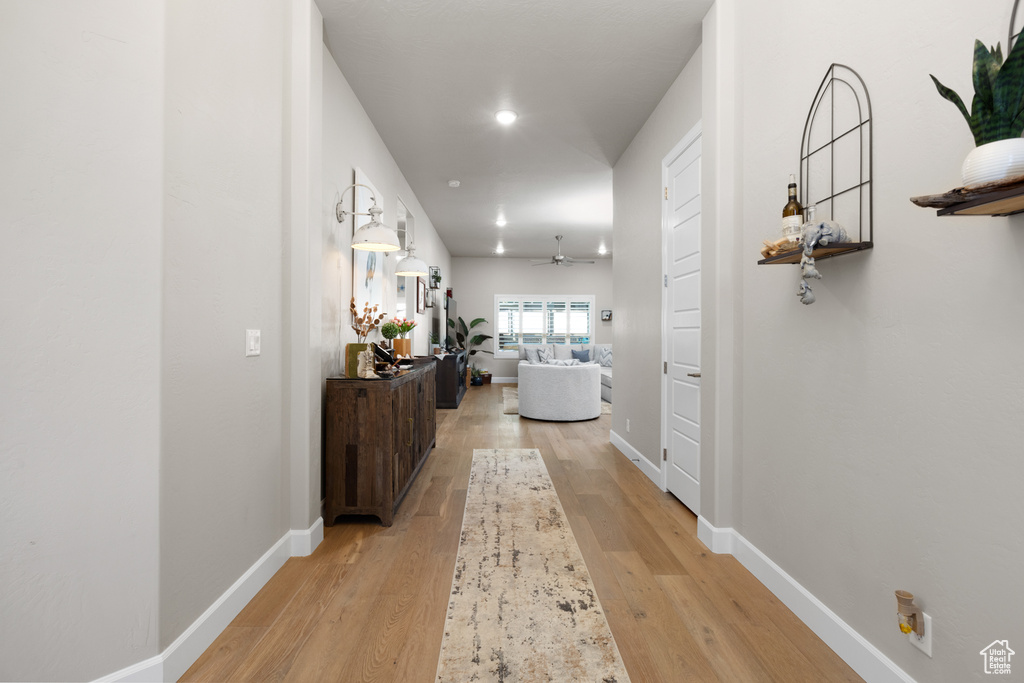 Corridor featuring light wood-style floors and recessed lighting