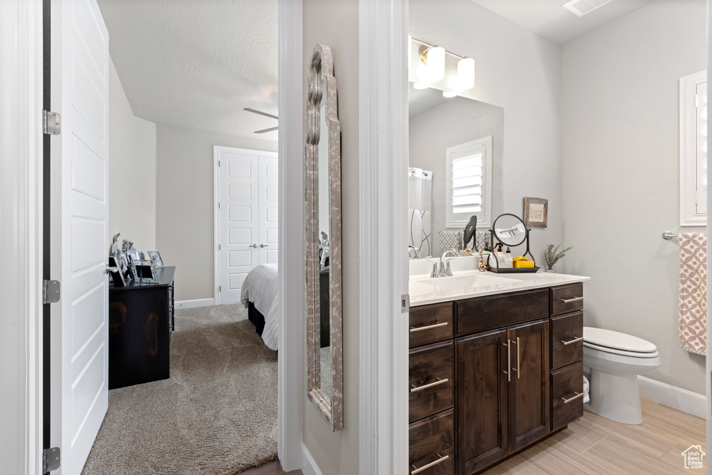 Bathroom featuring vanity, connected bathroom, and ceiling fan