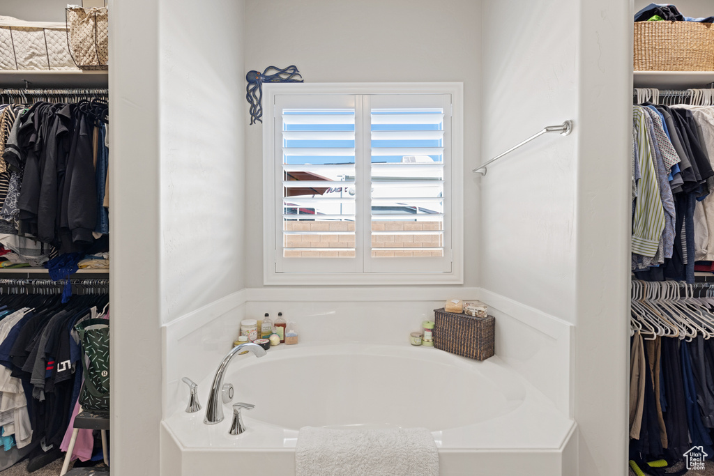 Full bath with a garden tub and a spacious closet