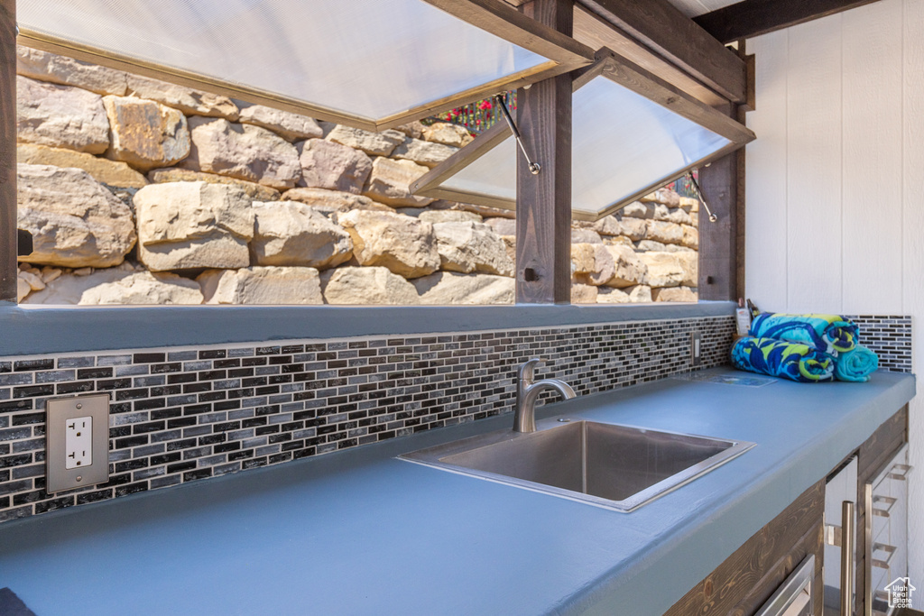Kitchen view of decorative backsplash and bar with sink