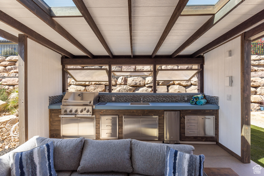 View of patio featuring area for grilling and a sink