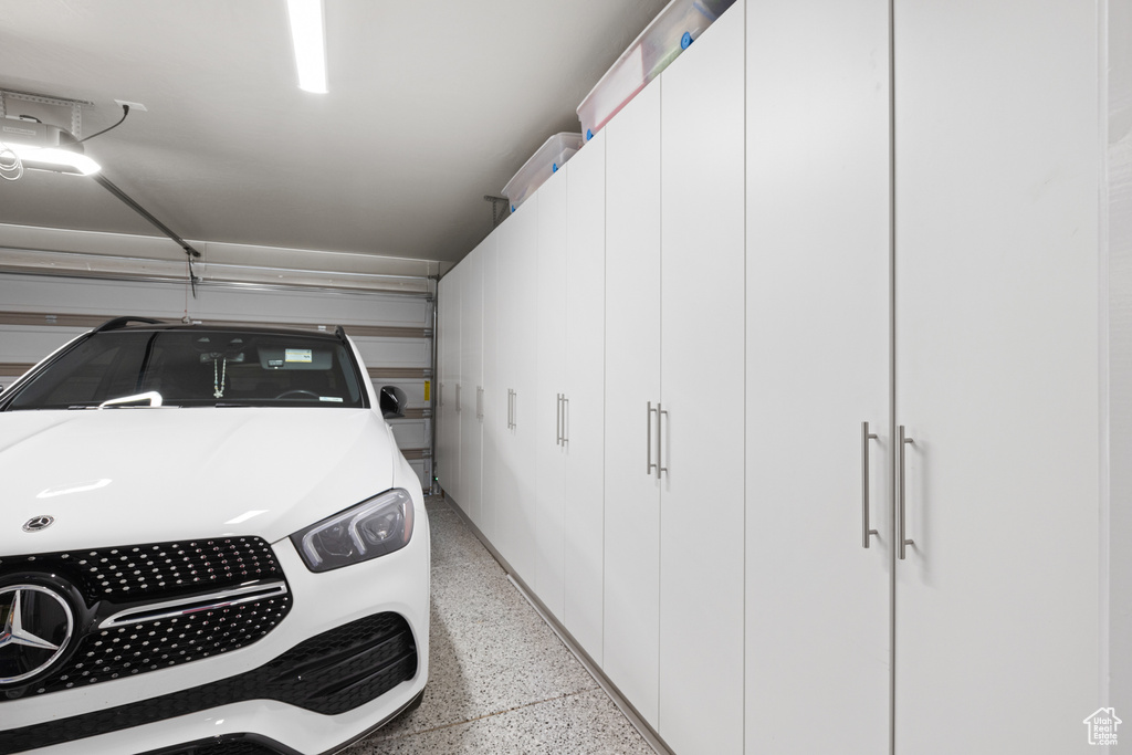 Garage with washer / clothes dryer and a garage door opener