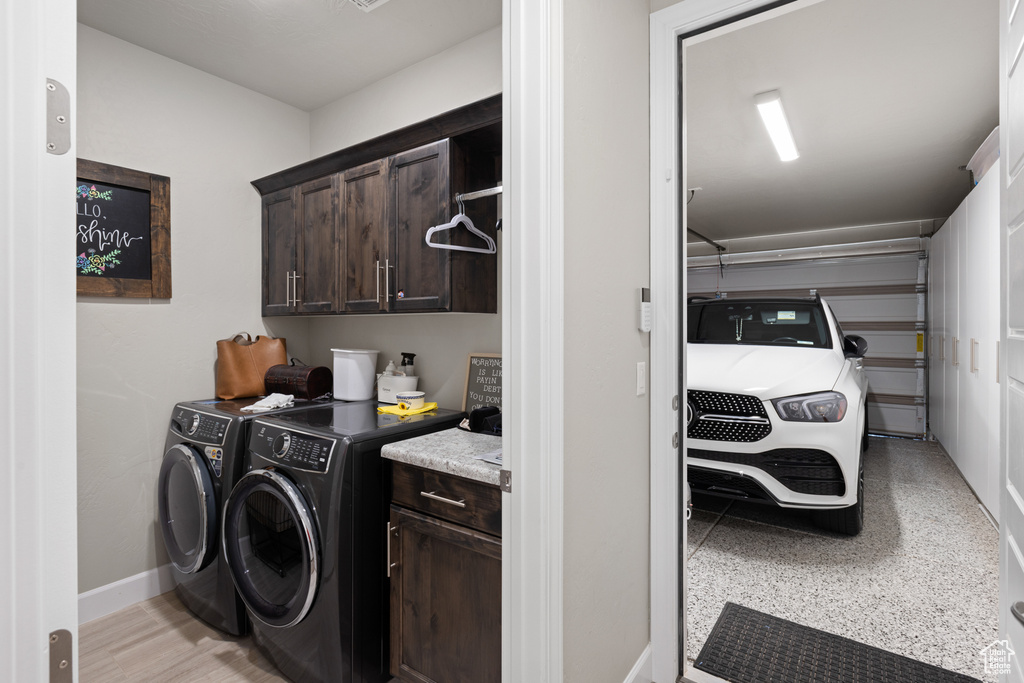 Washroom with cabinet space and washer and dryer