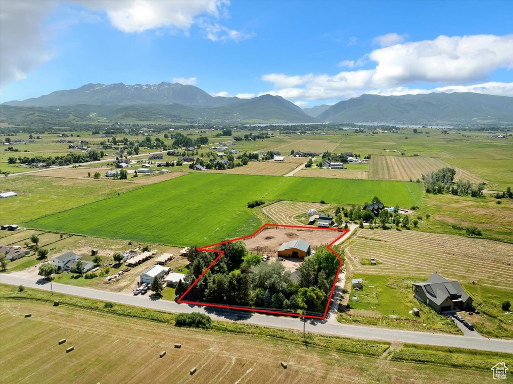 Aerial view of sparsely populated area with a mountain backdrop and property boundaries highlighted