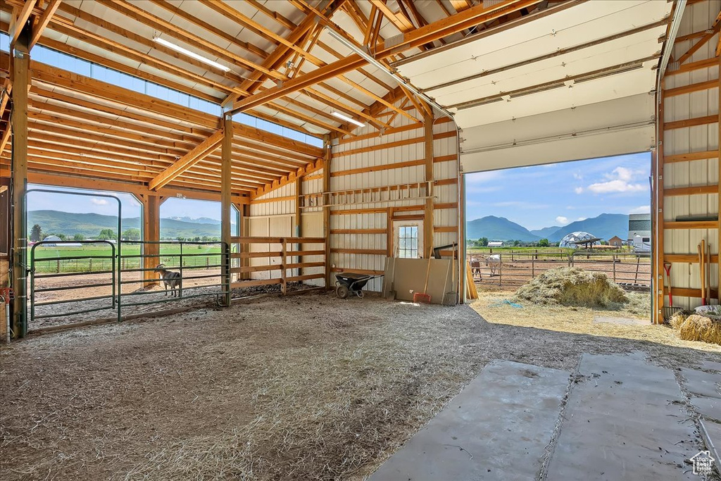 Horse barn with a mountain view and a view of countryside