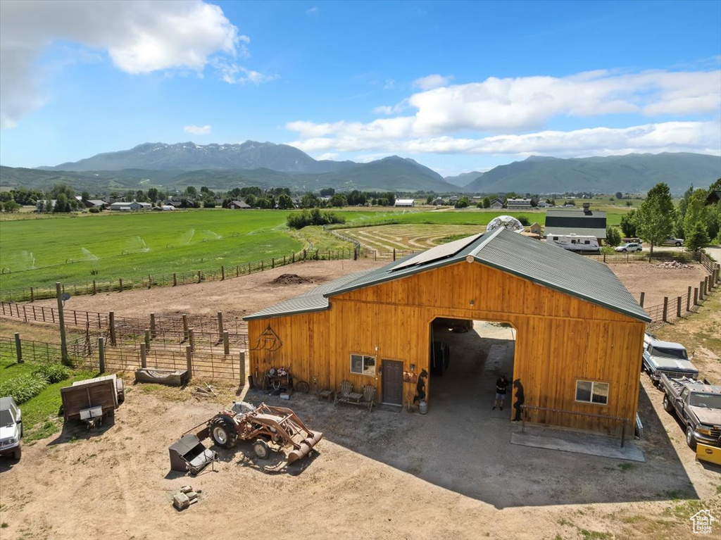 View of outbuilding with a mountain view, a view of countryside, and an exterior structure