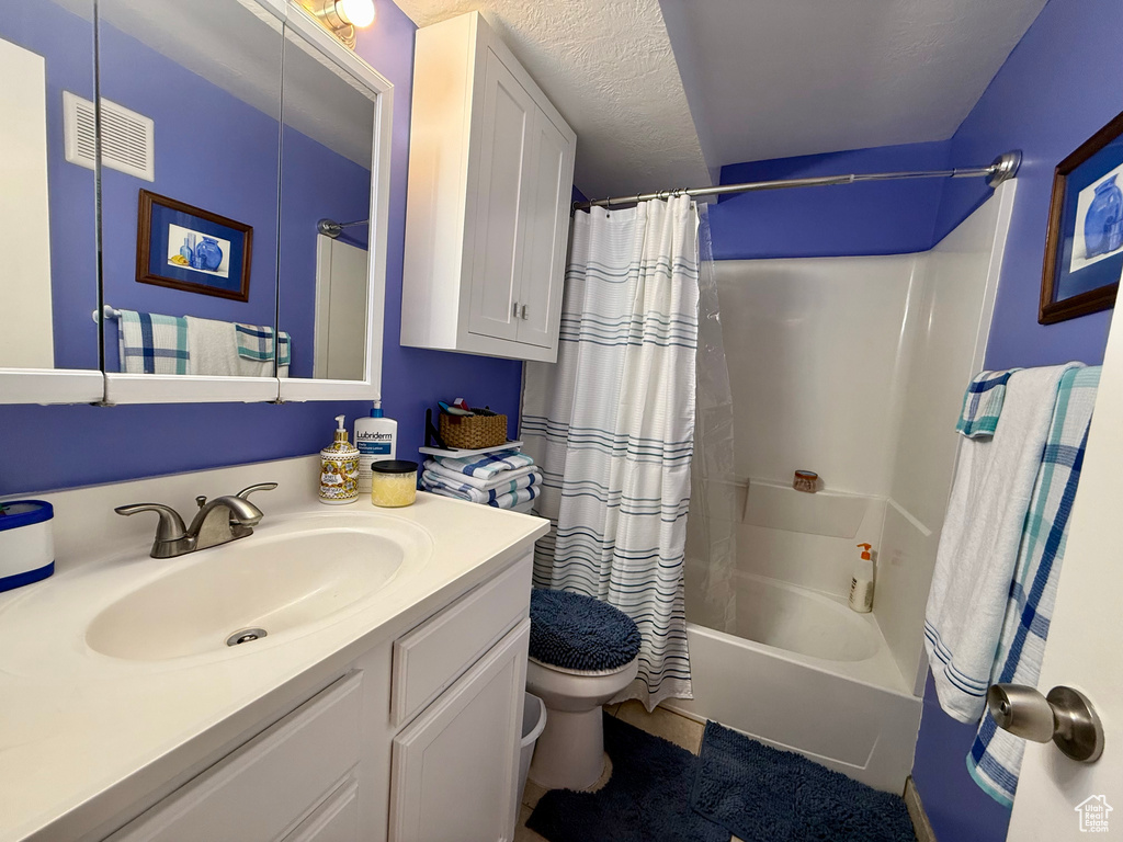 Full bath with vanity and shower / bath combination with curtain