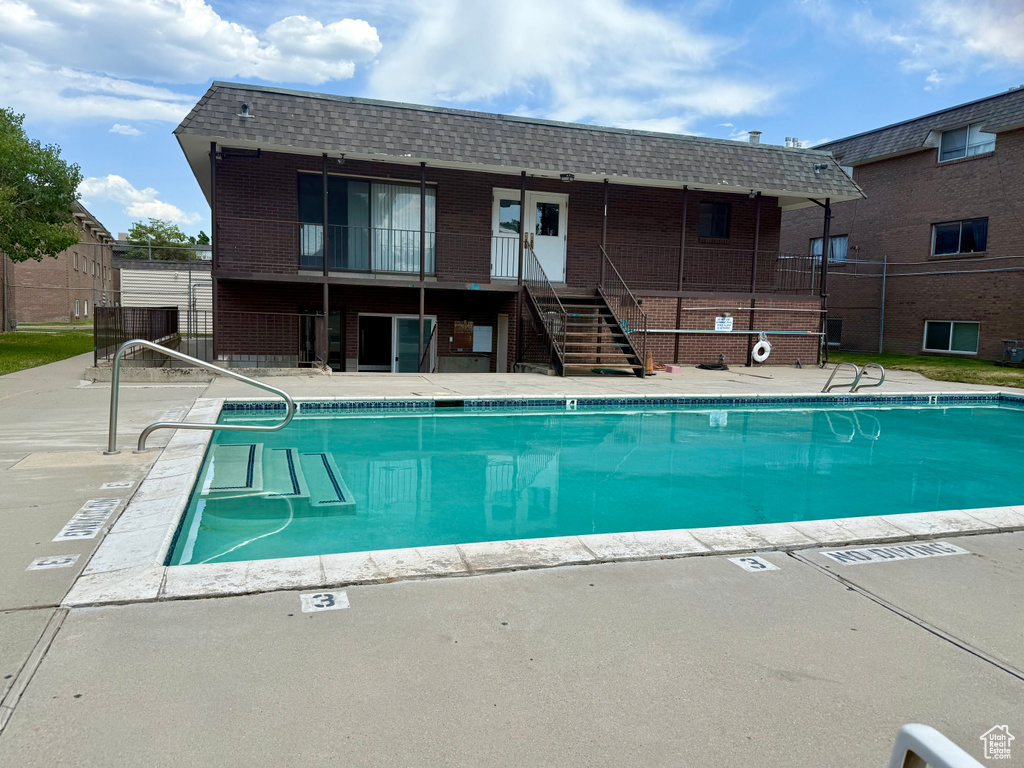 Community pool with stairs and a patio