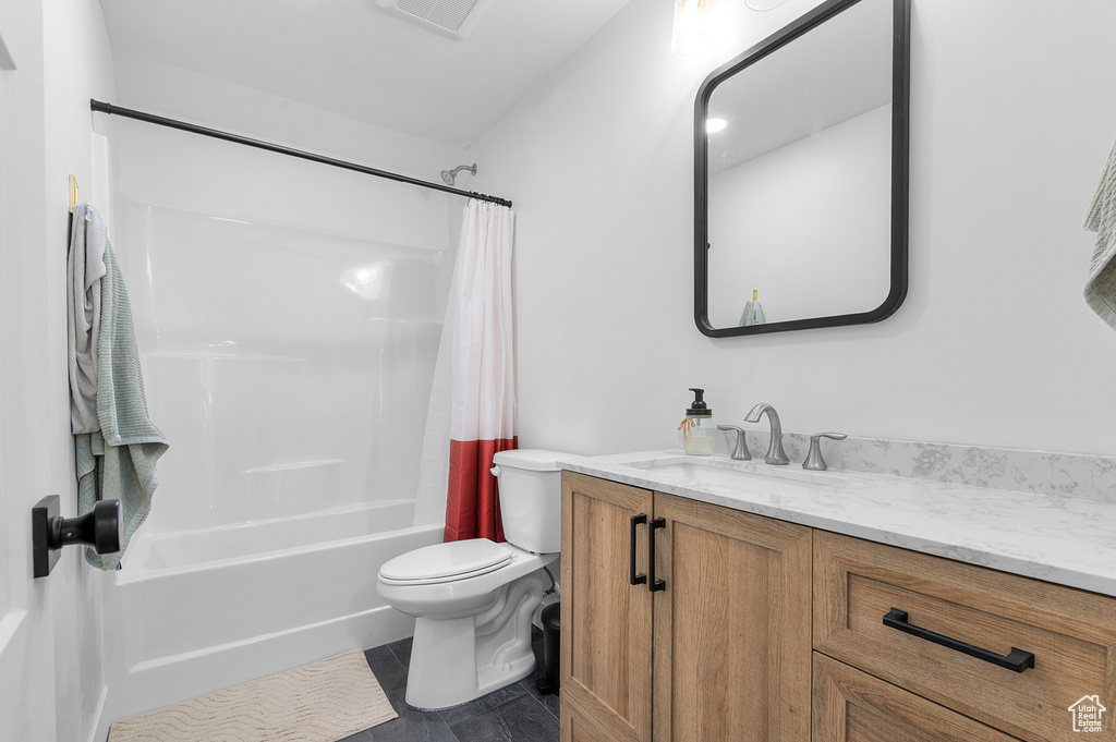 Full bath with vanity, shower / bath combination with curtain, and tile patterned floors