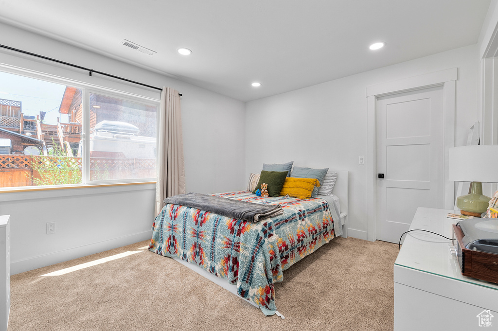 Carpeted bedroom with recessed lighting