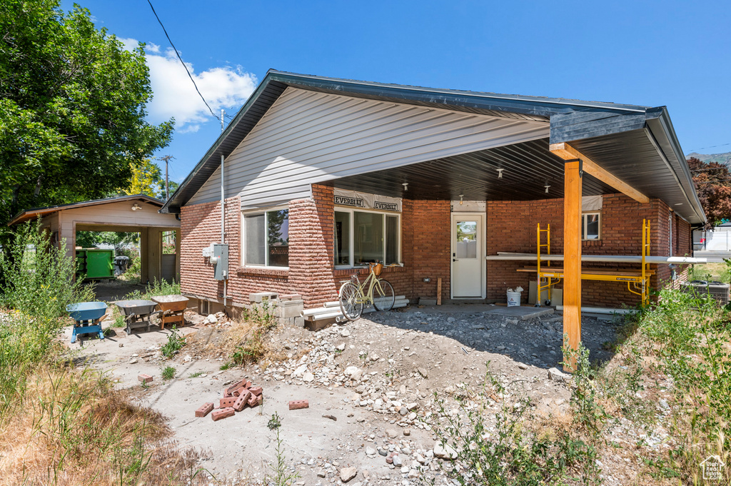 Rear view of house with brick siding
