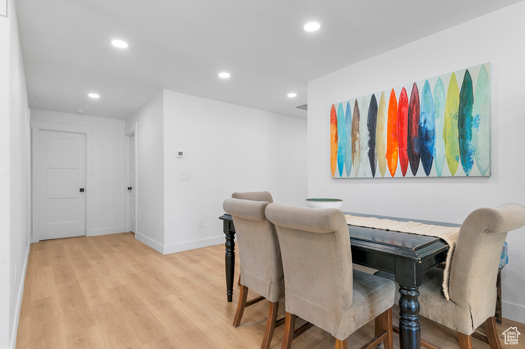 Dining space with light wood-style flooring and recessed lighting