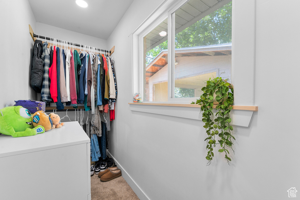 Walk in closet featuring carpet flooring