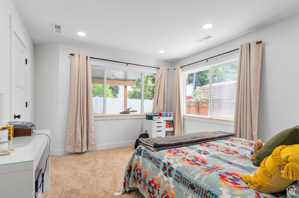 Bedroom featuring light carpet and recessed lighting