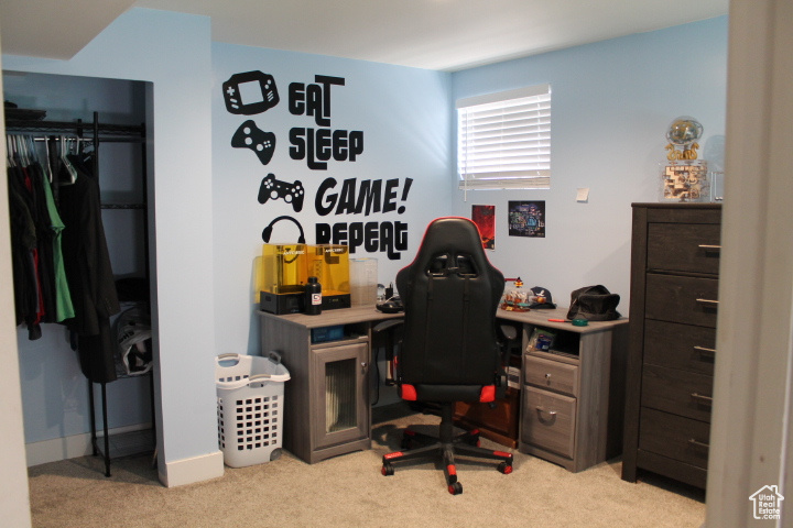 Home office featuring light carpet and baseboards