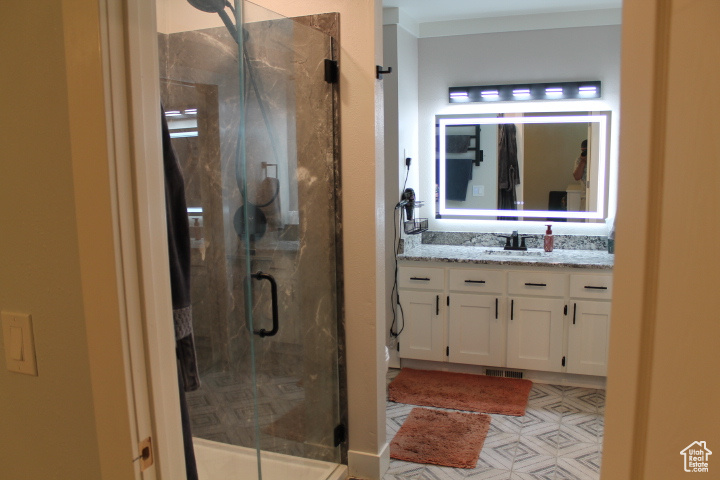 Bathroom featuring vanity and a stall shower