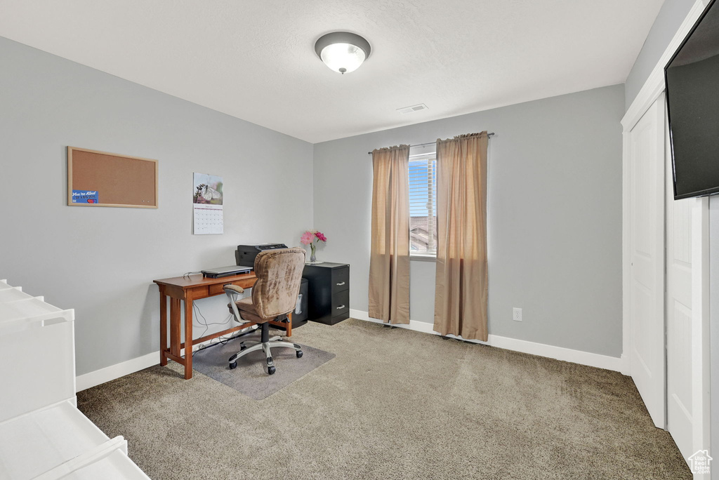 Carpeted office with baseboards