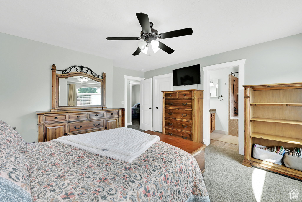 Bedroom with carpet flooring, ceiling fan, and ensuite bathroom