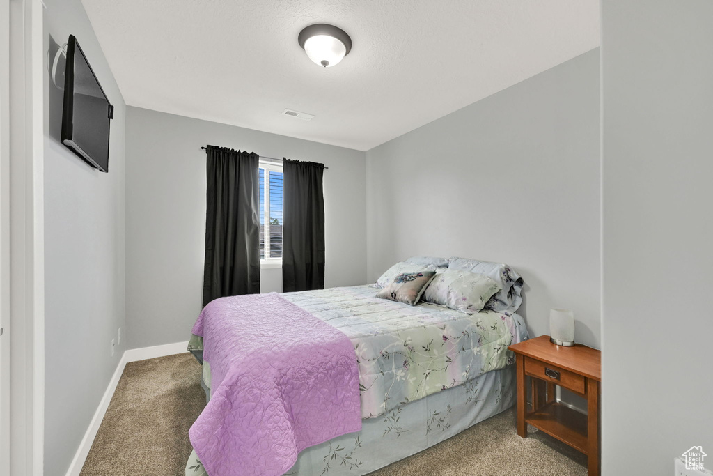 Carpeted bedroom with baseboards