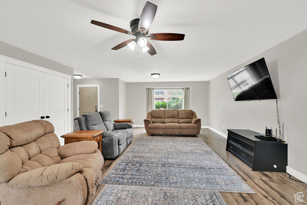 Living area featuring ceiling fan and wood finished floors