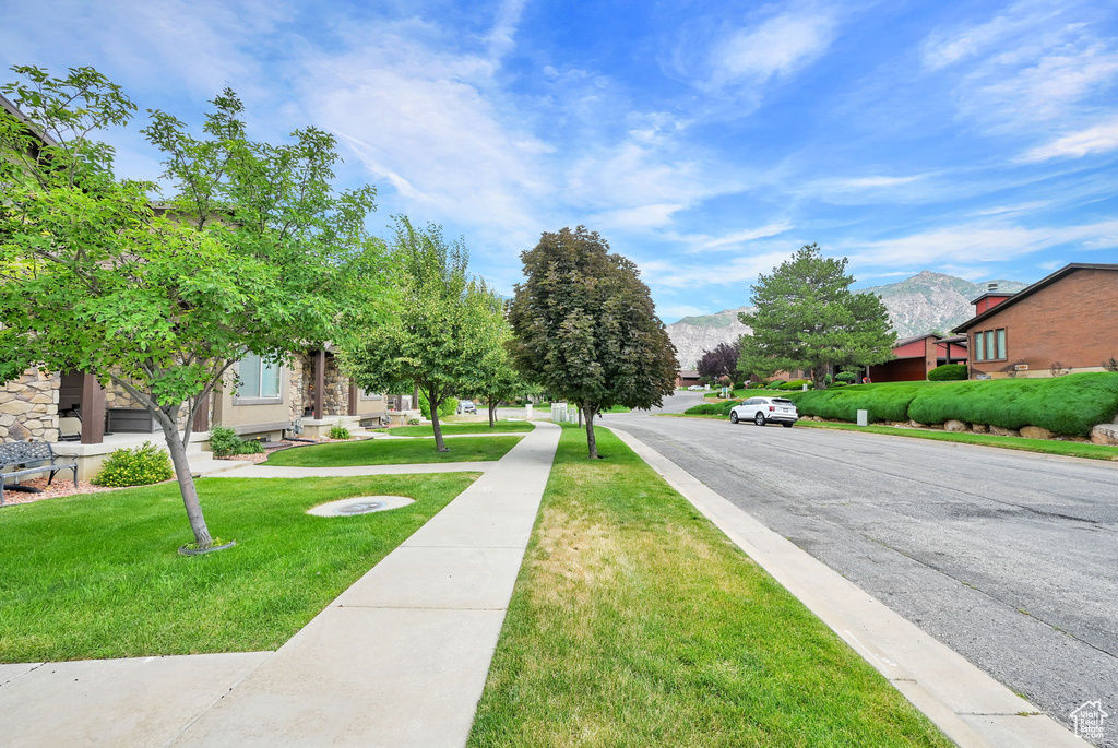 View of asphalt street with a mountain view and sidewalks