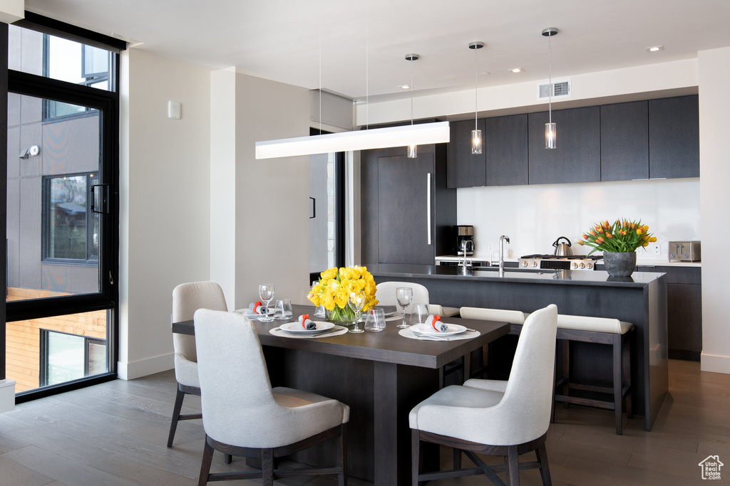 Dining area featuring dark wood-type flooring and recessed lighting