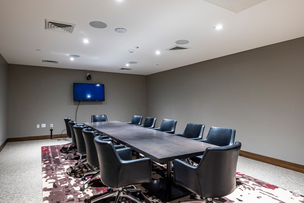 Carpeted dining area with baseboards