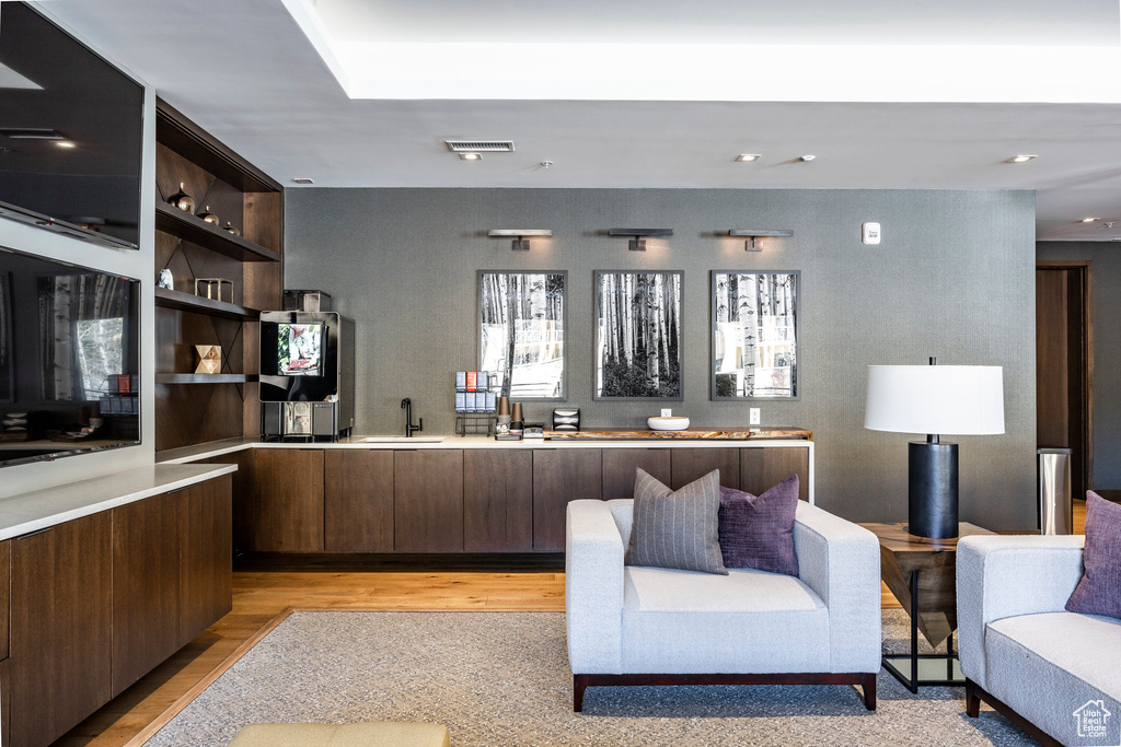 Home office with light wood-style flooring and recessed lighting
