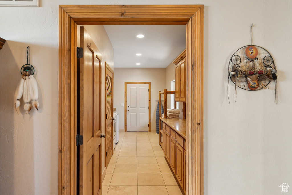 Hallway featuring light tile patterned floors and recessed lighting