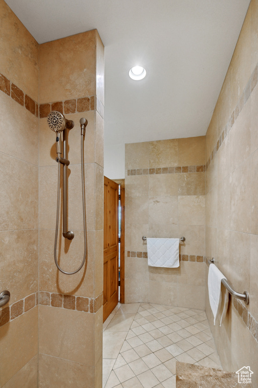 Bathroom featuring tiled shower and tile patterned floors