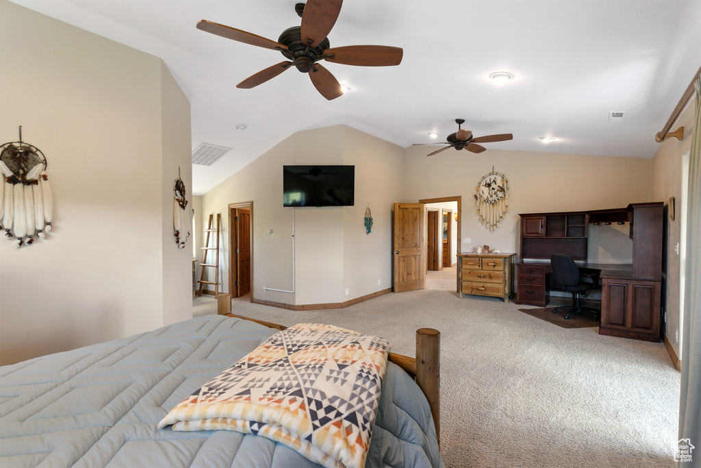 Bedroom with a desk, vaulted ceiling, light colored carpet, and ceiling fan