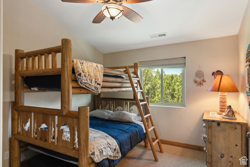 Bedroom featuring ceiling fan and carpet floors