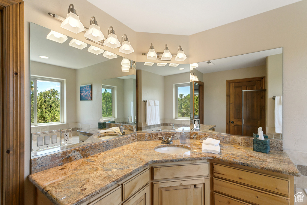 Full bathroom with a bath and vanity