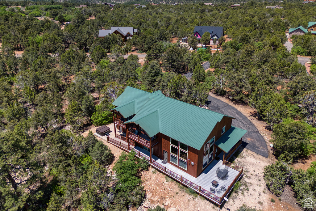 Aerial view of property and surrounding area featuring a heavily wooded area