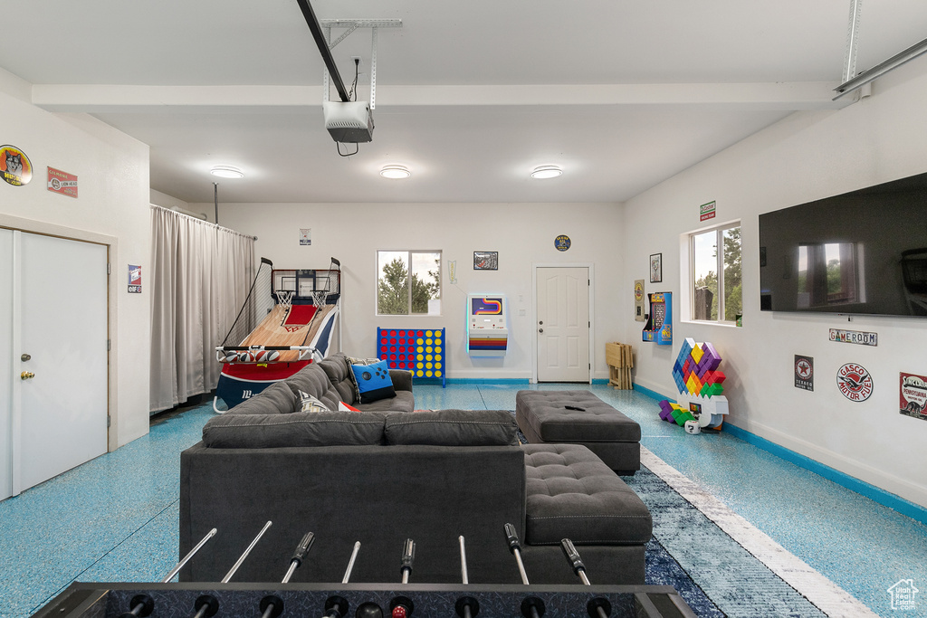 Living area featuring speckled floor and a garage