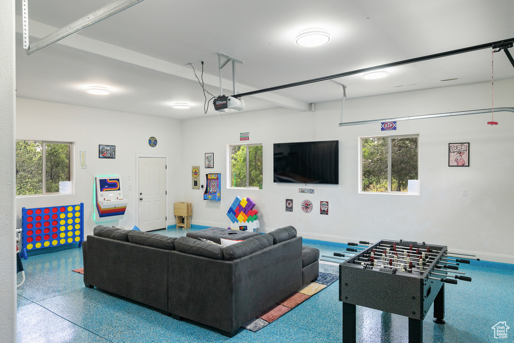 Living room with speckle patterned floor and a garage