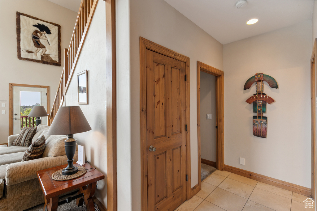 Foyer entrance with light tile patterned floors and recessed lighting
