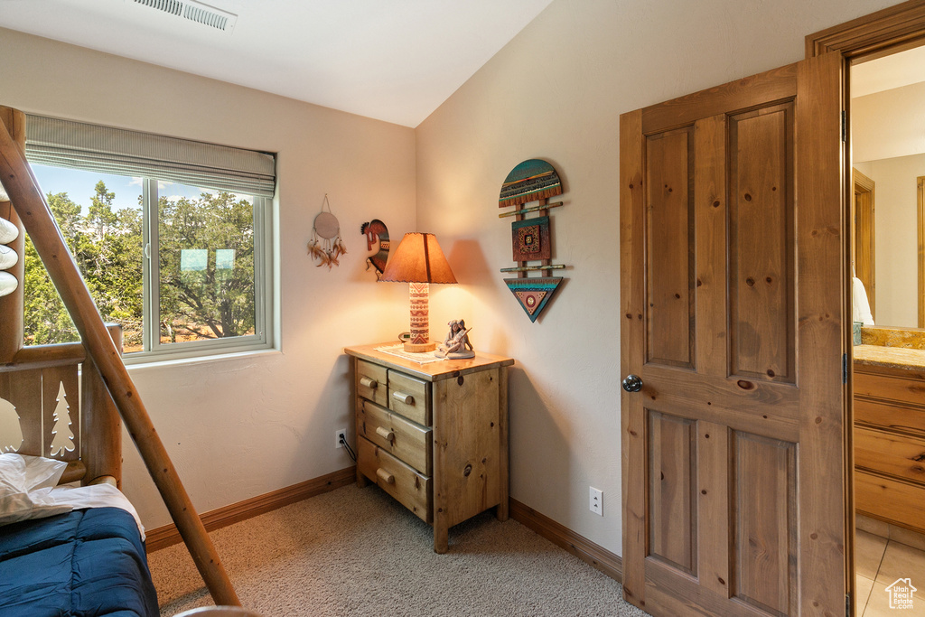 Bedroom featuring vaulted ceiling and light colored carpet